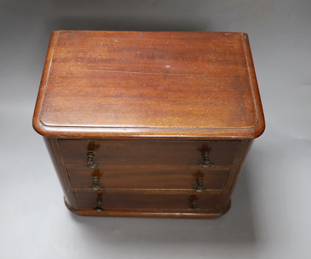 Two Victorian mahogany table top miniature chests of drawers, largest 39 cms wide x 38 cms high.